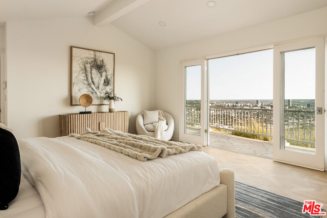 8527 Hedges Way Los Angeles, CA 90069 - Photo 9 of 25 a bedroom with a large bed and a large window