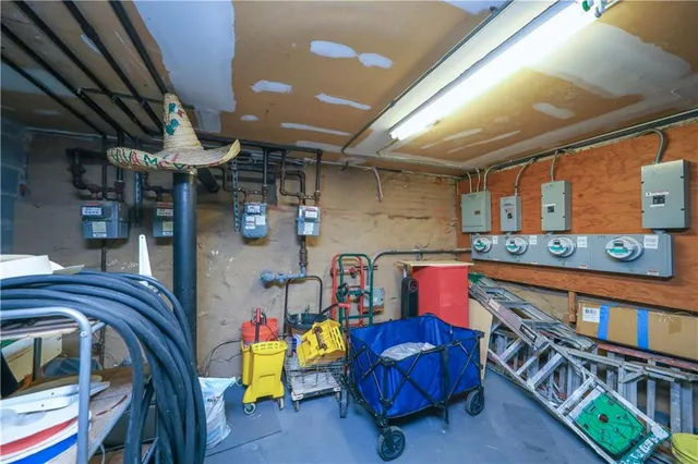 a utility room with stainless steel appliances and furniture