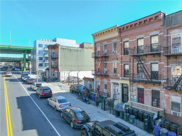 a city street filled with lots of traffic and tall buildings