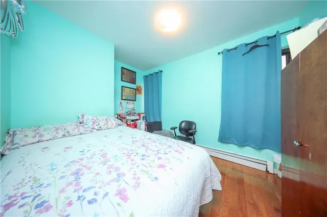 a bedroom with a bed and a dresser