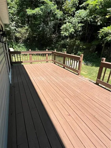 a view of balcony with deck and wooden floor