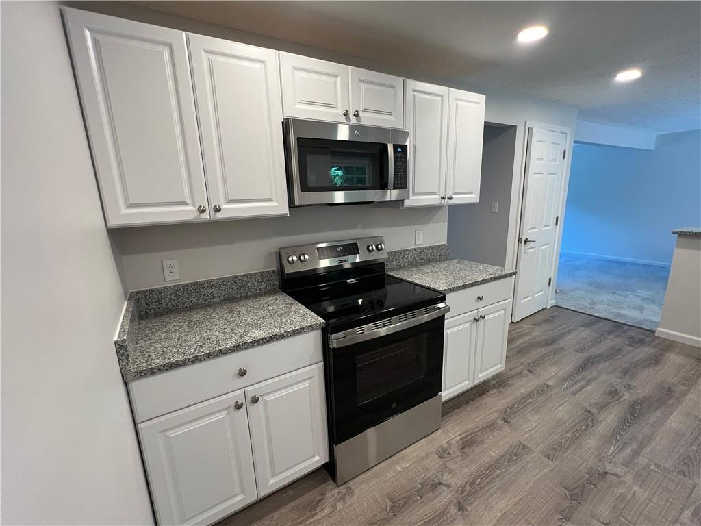 8822 Sloop Road Pittsburgh, PA 15237 - Photo 6 of 27 a kitchen with granite countertop white cabinets and stainless steel appliances