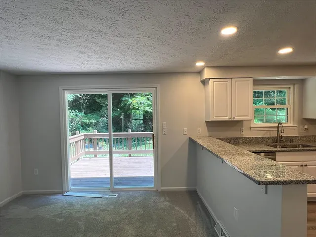 a kitchen with a sink and a large window