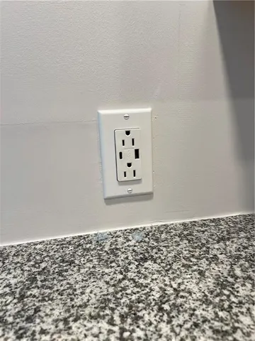 an empty room with painting on the wall