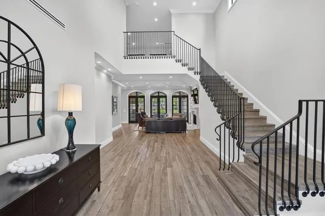 a view of a dining room with furniture a chandelier and wooden floor