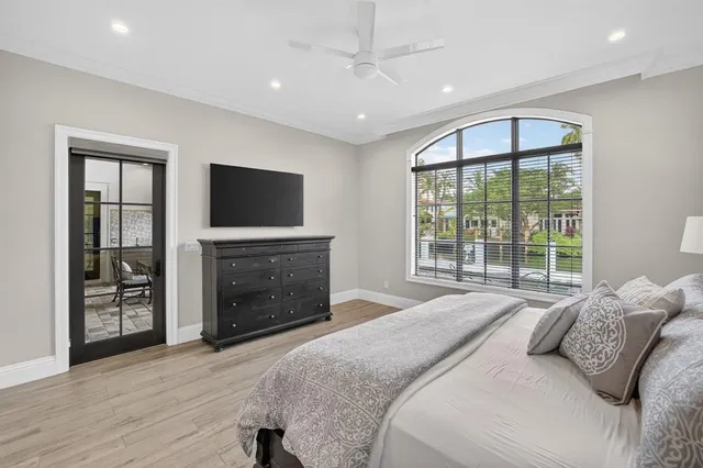 a front view of a house with a garden and trees