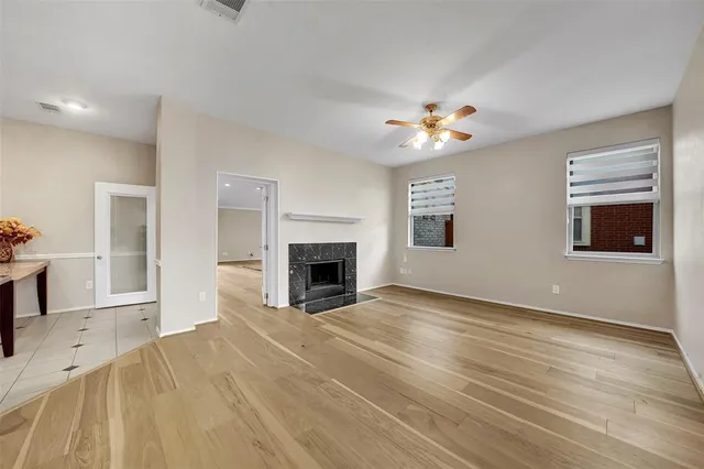 a view of an empty room with window and fireplace