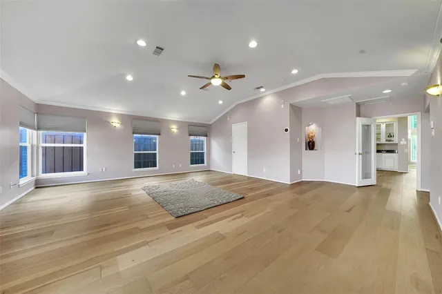a view of an empty room and a kitchen