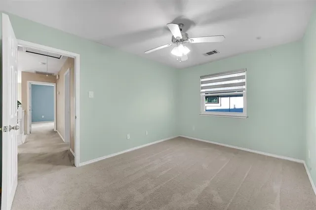 a view of a livingroom with a ceiling fan and window