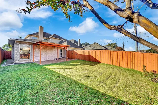 a backyard of a house with table and chairs