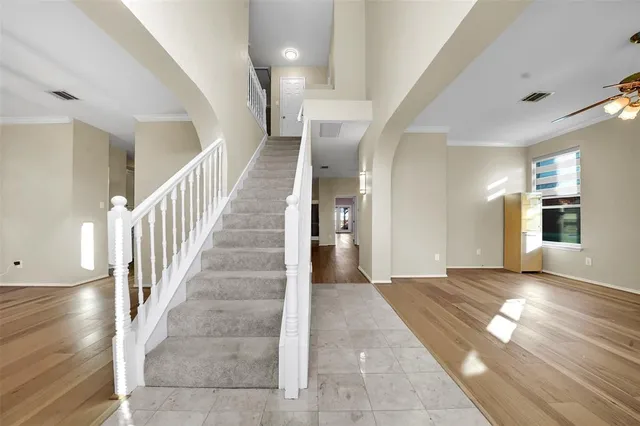 a view of entryway and hall with wooden floor