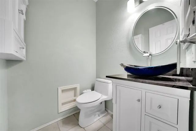a bathroom with a toilet and a mirror