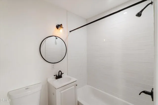 a bathroom with a sink a mirror and a shower