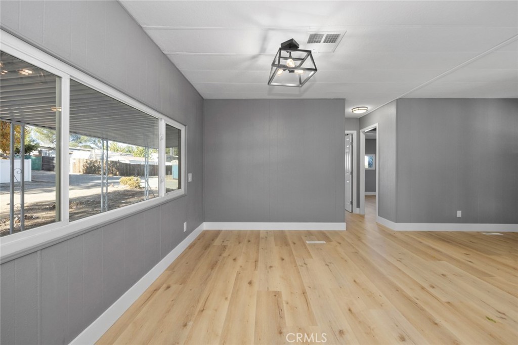 17221 Hidalgo Drive Perris, CA 92570 - Photo 13 of 32 a view of empty room with wooden floor and fan