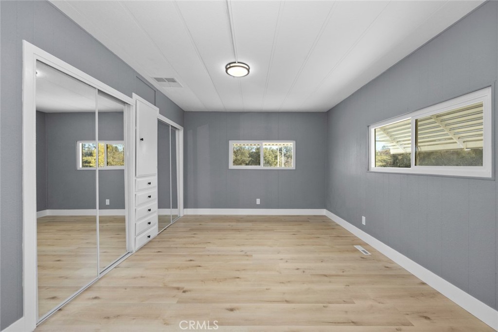 17221 Hidalgo Drive Perris, CA 92570 - Photo 14 of 32 an empty room with window and wooden floor