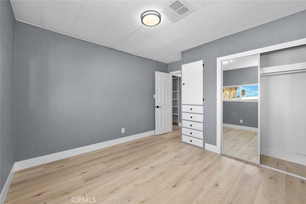 17221 Hidalgo Drive Perris, CA 92570 - Photo 21 of 32 an empty room with closet and wooden shelves
