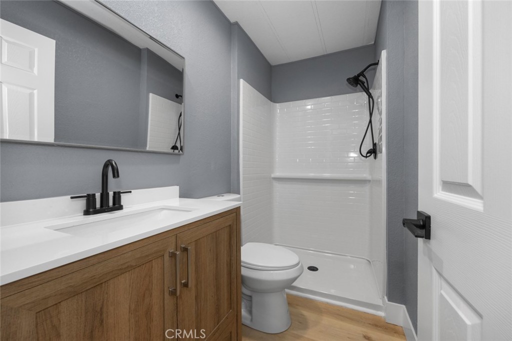 17221 Hidalgo Drive Perris, CA 92570 - Photo 22 of 32 a bathroom with a granite countertop sink toilet and shower