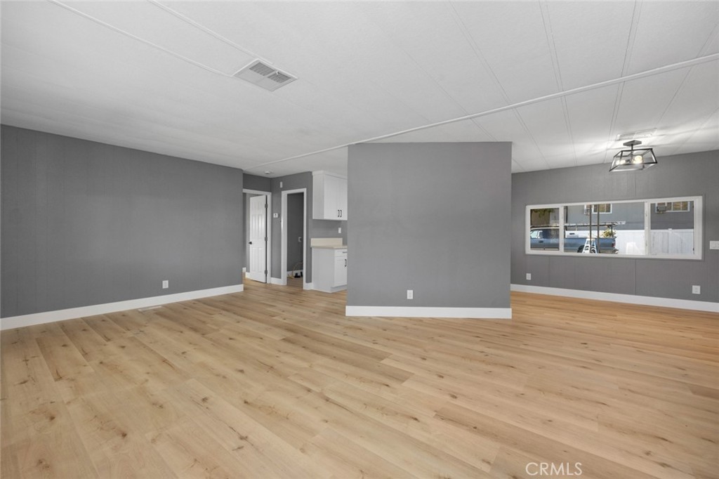 17221 Hidalgo Drive Perris, CA 92570 - Photo 5 of 32 a view of an empty room with wooden floor and a window