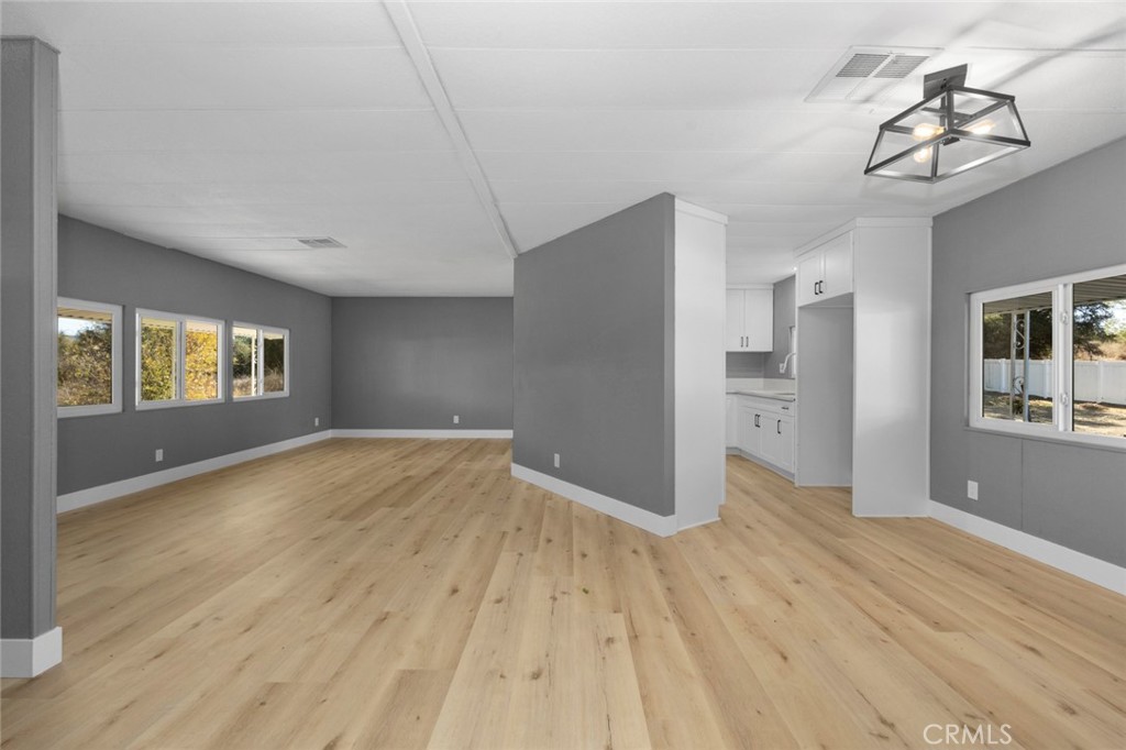 17221 Hidalgo Drive Perris, CA 92570 - Photo 6 of 32 a view of empty room with wooden floor and windows