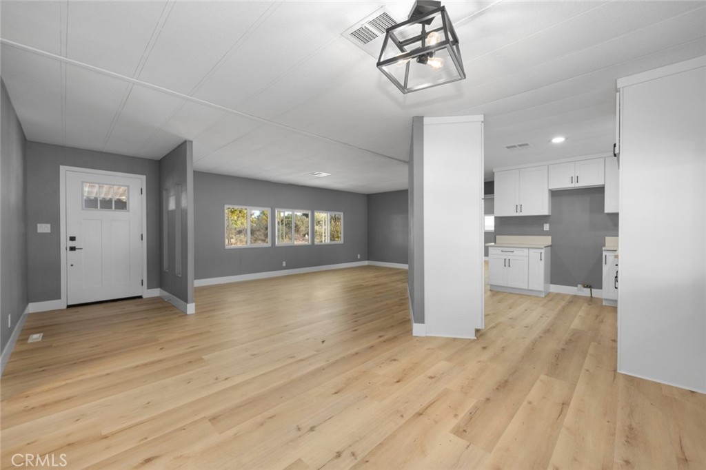 17221 Hidalgo Drive Perris, CA 92570 - Photo 7 of 32 a view of a room with wooden floor refrigerator and windows