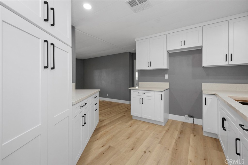 17221 Hidalgo Drive Perris, CA 92570 - Photo 8 of 32 a kitchen with granite countertop white cabinets and white appliances