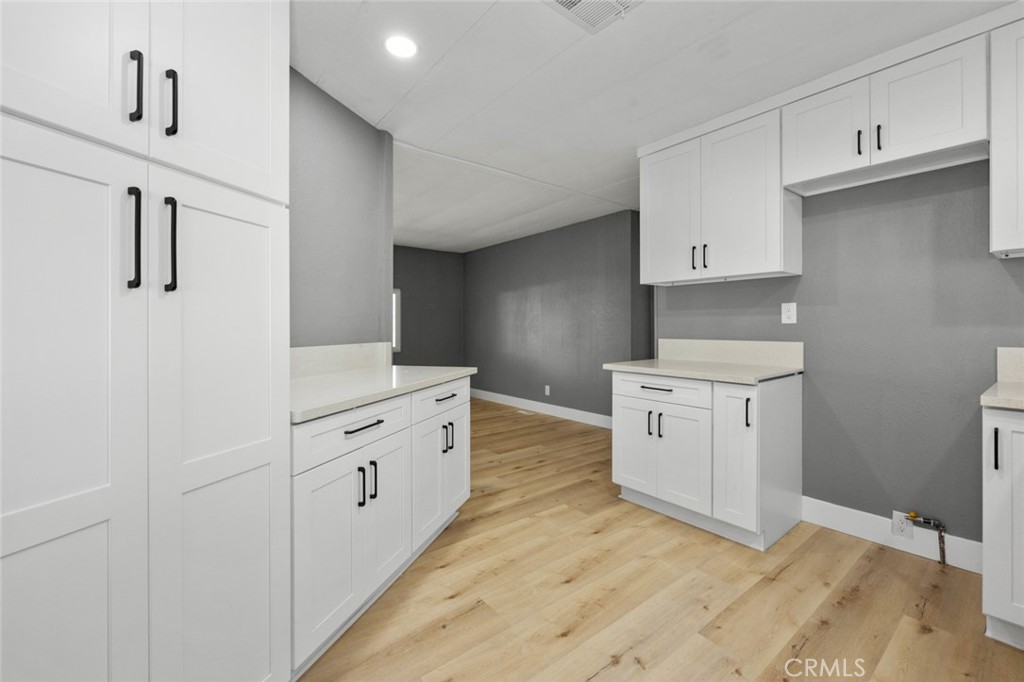 17221 Hidalgo Drive Perris, CA 92570 - Photo 10 of 32 a kitchen with white cabinets and white appliances