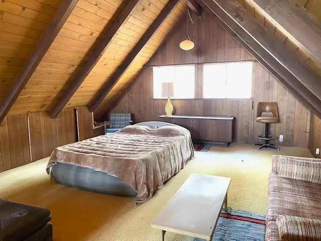 a bedroom with a bed and window