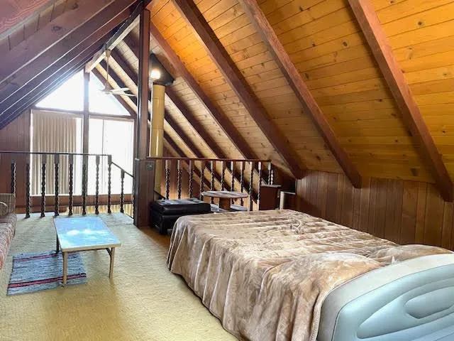 a bed sitting in a bedroom next to a window