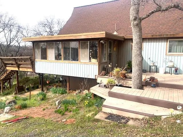 a view of a house with backyard porch and sitting area