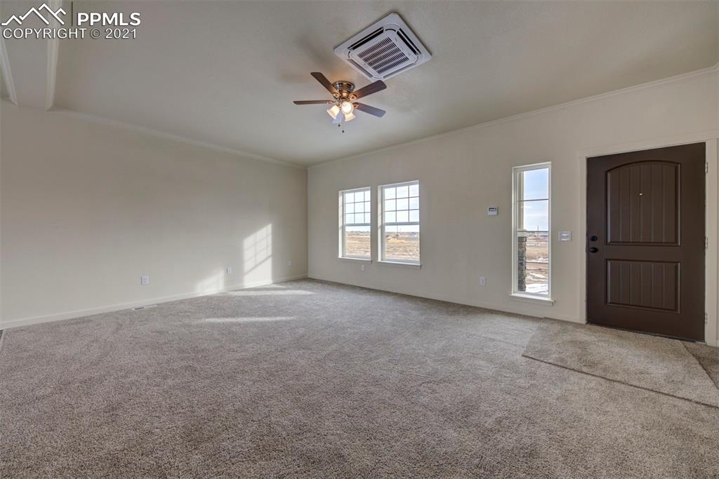 1075 Yoder Road Yoder, CO 80864 - Photo 2 of 14 an empty room with windows and cabinet