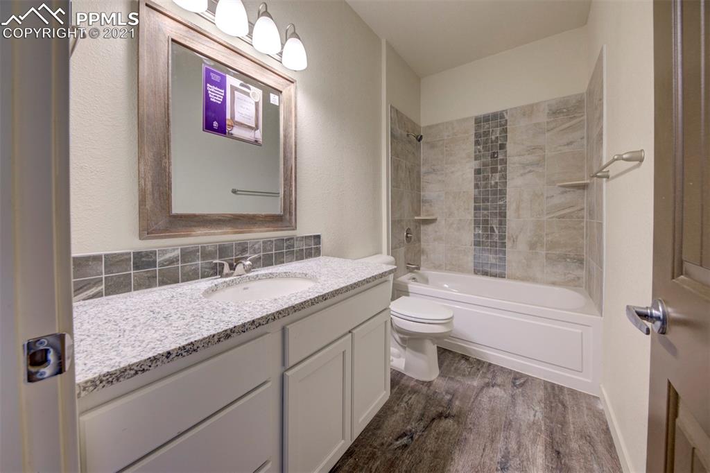 1075 Yoder Road Yoder, CO 80864 - Photo 13 of 14 a bathroom with a granite countertop sink toilet and shower