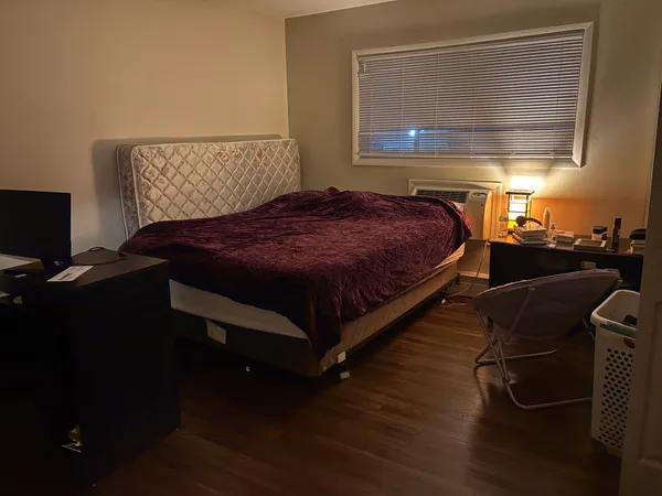 a bedroom with a bed and window