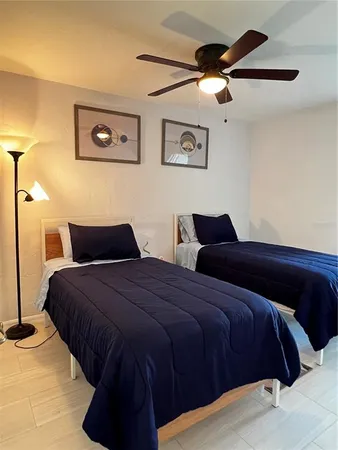 a bedroom with a bed and a lamp