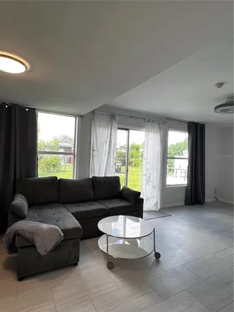 a living room with furniture and a large window