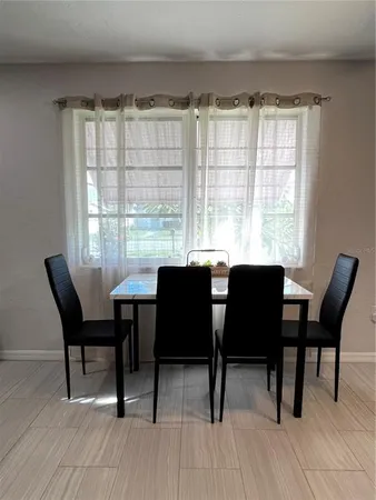 a dining room with furniture and wooden floor