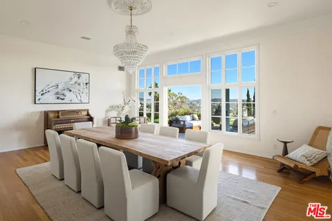 a view of a swimming pool with a garden and patio