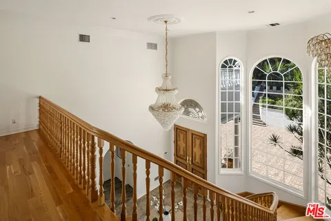 a living room with fireplace furniture and a wooden floor