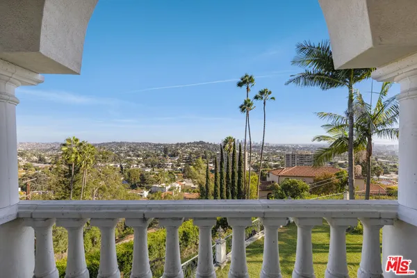 a room with pool table and windows