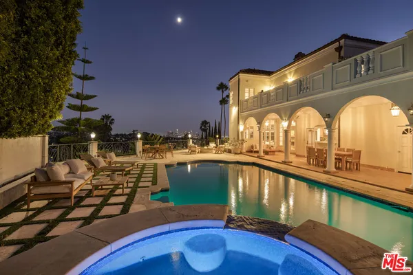 a view of a house with a swimming pool and a patio