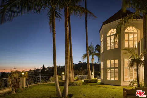 an aerial view of residential houses with city view