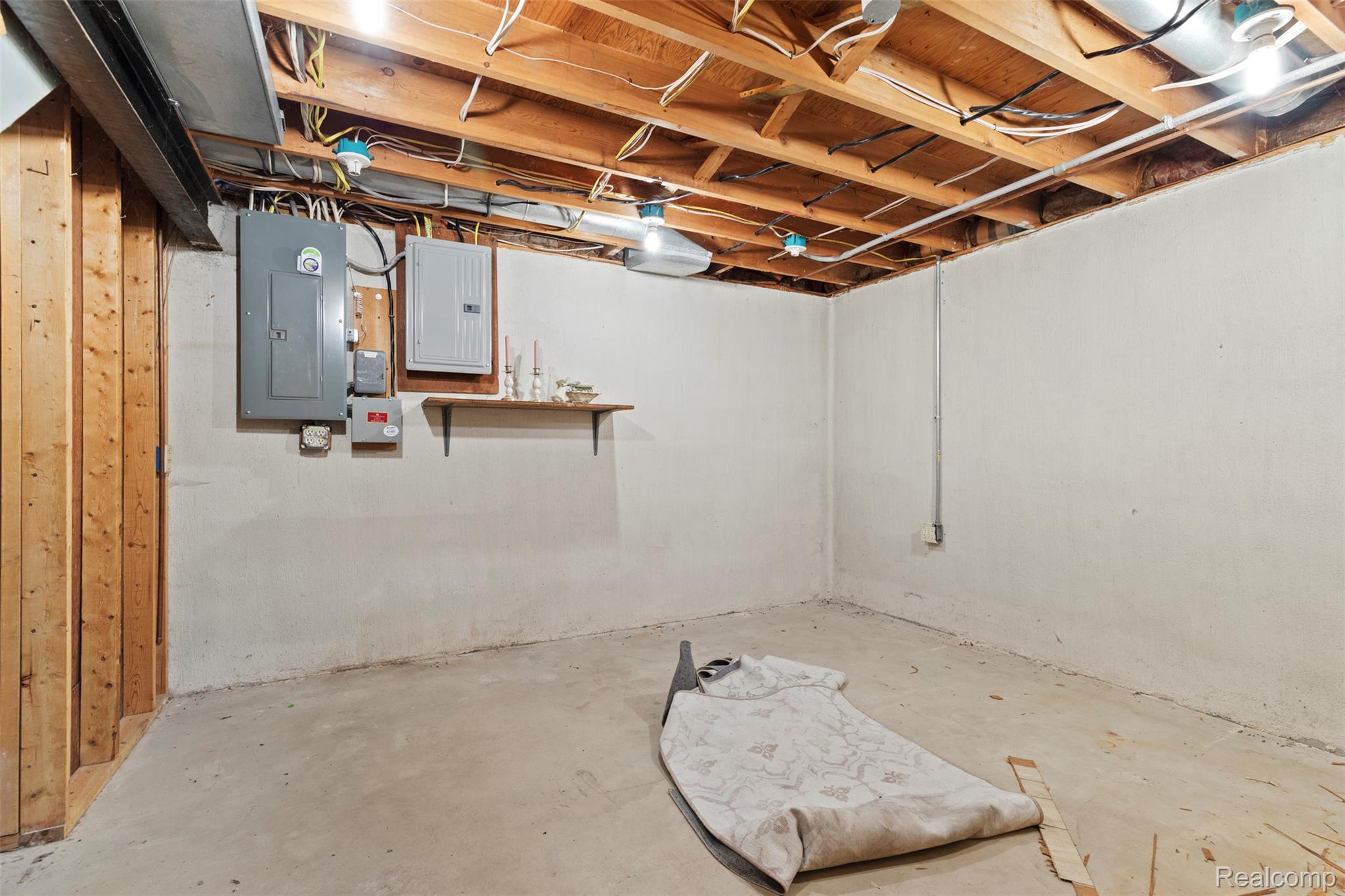 309 Windy Bluff Street Flushing, MI 48433 - Photo 25 of 32 Unfinished basement featuring exposed wood joists, concrete flooring, and white painted foundation walls