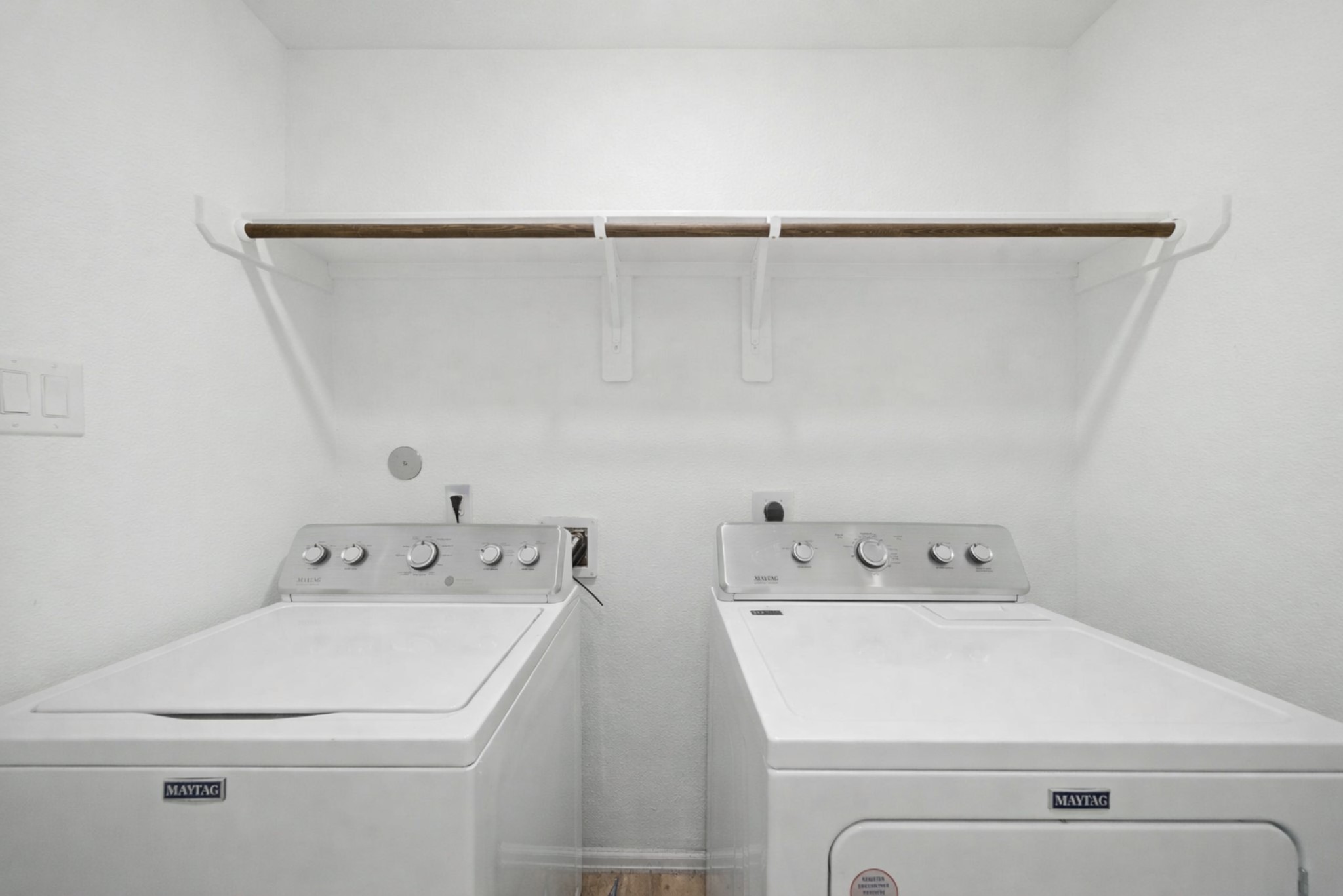 14502 Woodcott Warren Way Rosharon, TX 77583 - Photo 15 of 37 Convenient laundry area with side-by-side washer and dryer setup, tucked neatly behind doors for a clean look.