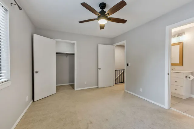a bathroom with a toilet a sink a bath tub and mirror