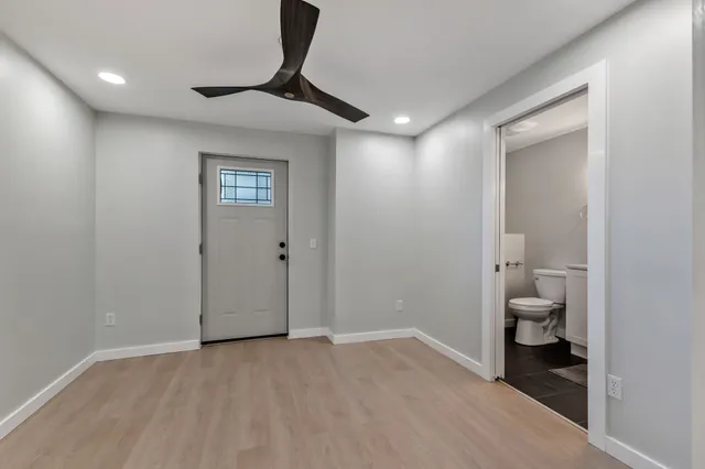 a view of a room that has a bed and a mirror