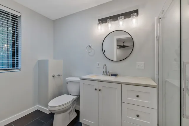 a bathroom with a shower and a sink