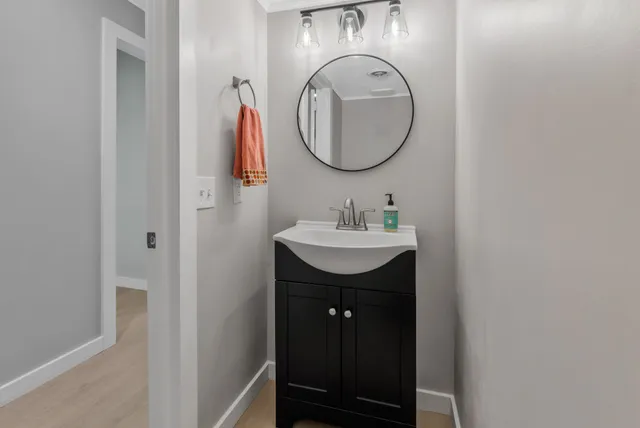 a bathroom with a granite countertop sink a toilet and shower