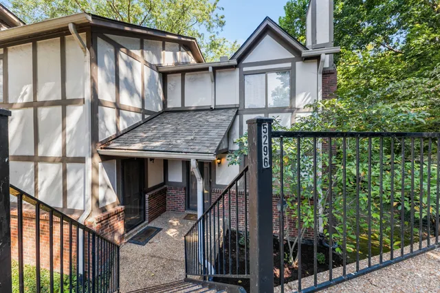 a view of house with wooden deck and outdoor space