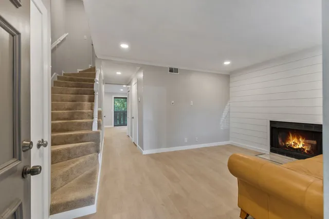 a view of an empty room and fire place