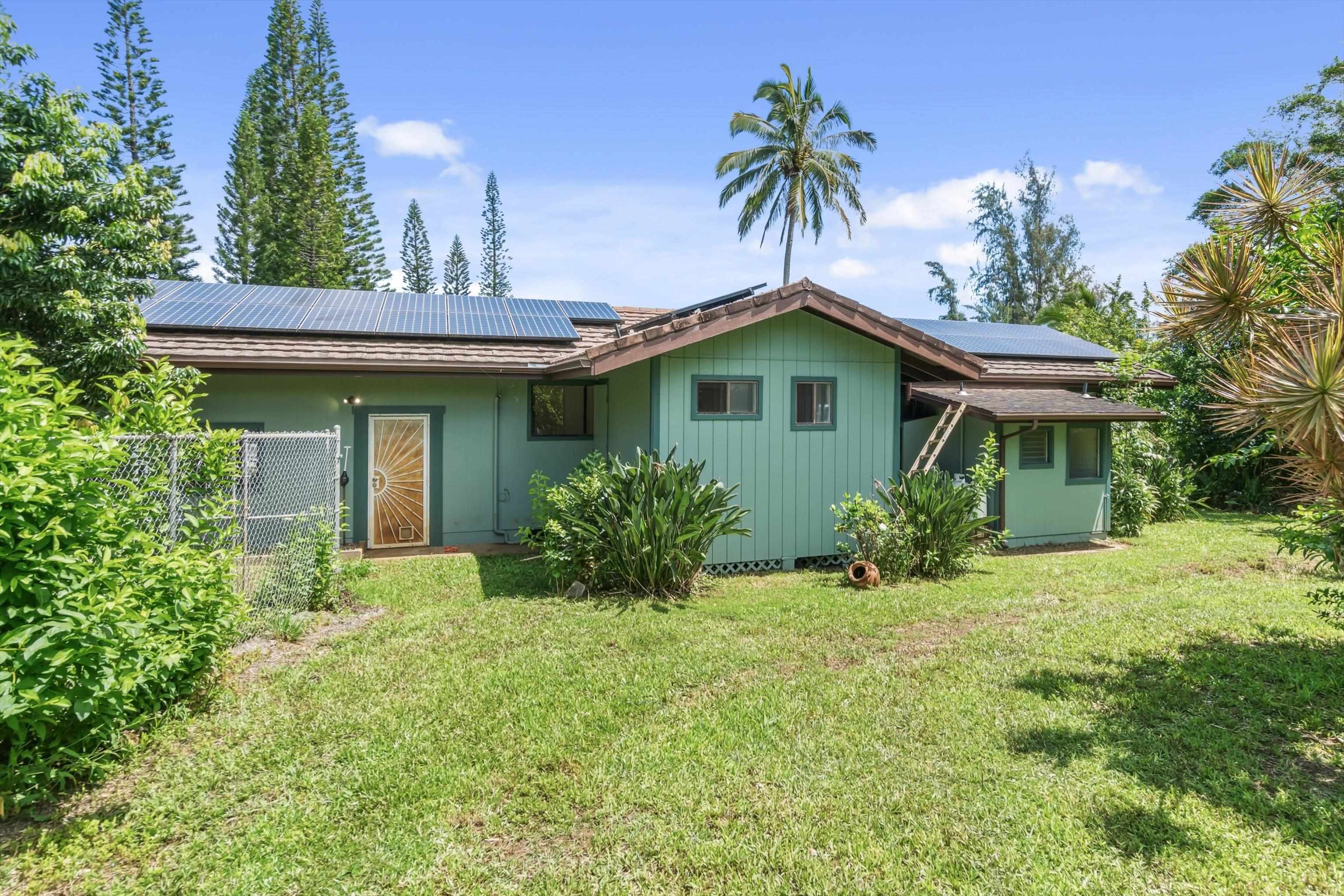 145 South Holokai Road Haiku, HI 96708 - Photo 36 of 50 a view of a house with a yard and potted plants