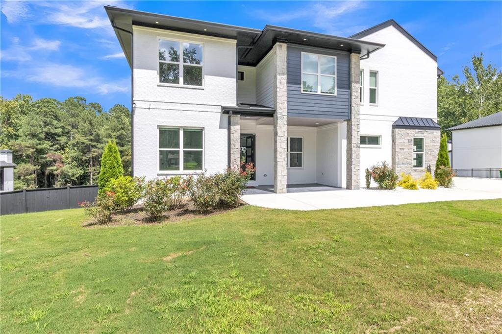 3671 Hamilton Mill Road Buford, GA 30519 - Photo 13 of 111 a view of a house with a yard and plants